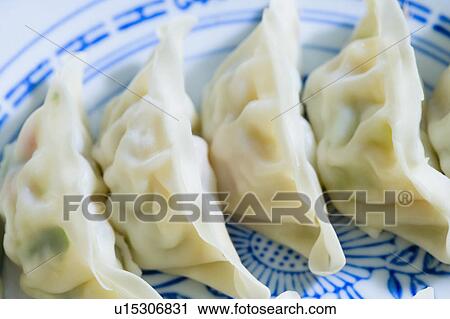 Stock Image - Close-up of Chinese dumplings on a plate. Fotosearch