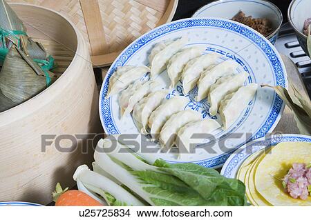 Picture - Close-up of Chinese dumplings with carrots and bok choys. Fotosearch