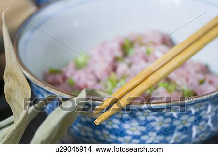Close-up of chopsticks on a bowl of stuffing meat View Large Photo Image Picture - Close-up of chopsticks on a bowl of stuffing meat. Fotosearch