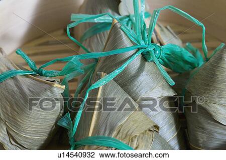 Stock Image - Close-up of dumplings in a bamboo steamer. Fotosearch