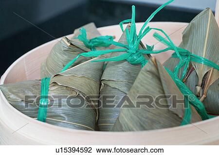 Stock Image - Close-up of dumplings in a bamboo steamer. Fotosearch