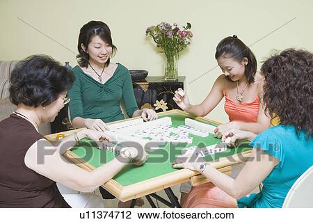 Four women playing with blocks at a table View Large Photo Image Stock Image - Four women playing with blocks at a table. Fotosearch