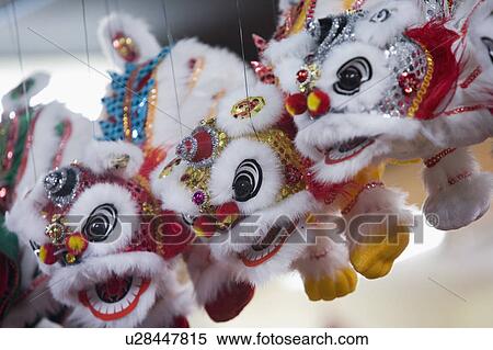 Stock Photography - Close-up of a Chinese lion puppet hanging in a store. Fotosearch