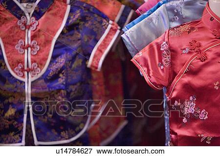 Close-up of dresses displayed on hangers View Large Photo Image Stock Photo - Close-up of dresses displayed on hangers. Fotosearch