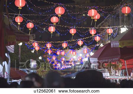 Stock Image - Crowd on the street decorated with Chinese lanterns at night, Chinatown, Singapore. Fotosearch