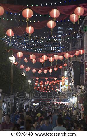 Stock Image - Crowd walking on the street decorated with Chinese lanterns at night, Chinatown, Singapore. Fotosearch