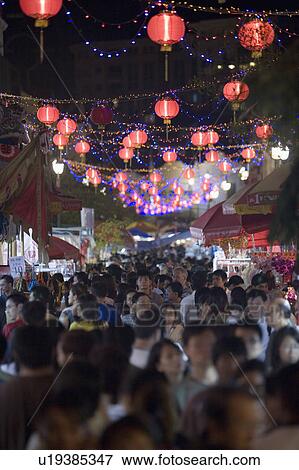 Stock Photo - Crowd walking on the street decorated with Chinese lanterns at night, Chinatown, Singapore. Fotosearch