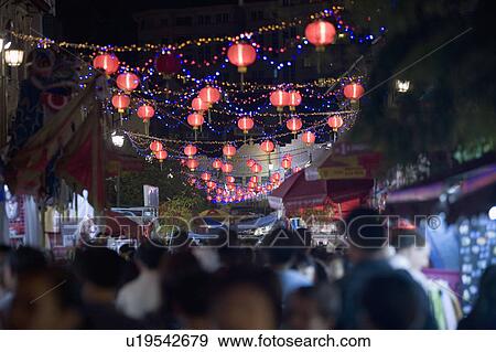 Crowd Walking On The Street Decorated With Chinese Lanterns At
