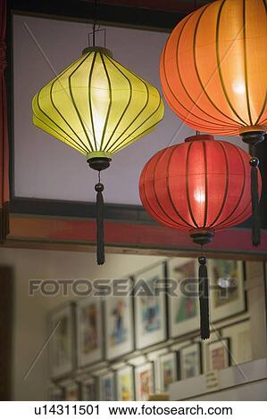 Stock Image - Low angle view of Chinese lanterns lit up. Fotosearch
