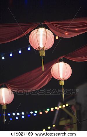 Low angle view of Chinese lanterns lit up at night View Large Photo Image Stock Photo - Low angle view of Chinese lanterns lit up at night. Fotosearch
