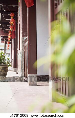 Stock Photo - Low angle view of Chinese lanterns hanging in a temple. Fotosearch