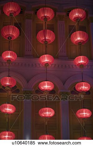 Stock Photography - Low angle view of Chinese lanterns hanging in front of a building. Fotosearch