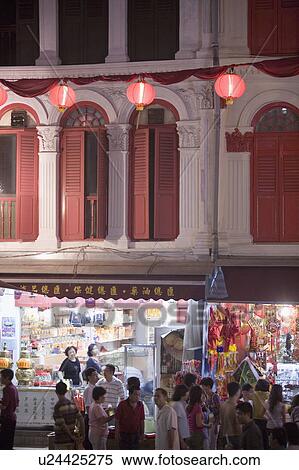 Stock Photography - People walking in a market at night, Chinatown, Singapore. Fotosearch