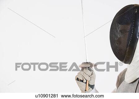 Close-up of a person wearing a fencing mask and holding a fencing foil View Large Photo Image Stock Image - Close-up of a person wearing a fencing mask and holding a fencing foil. Fotosearch