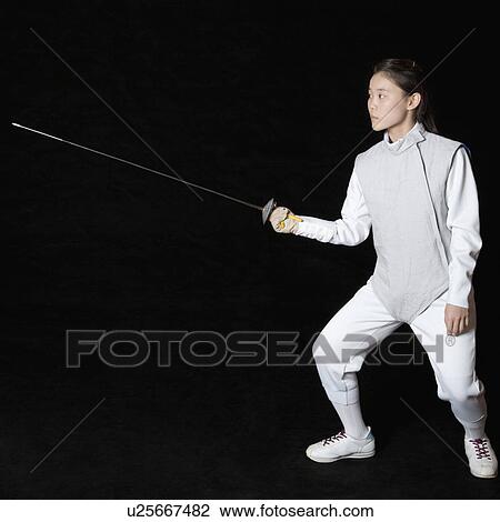Stock Image - Female fencer holding a fencing foil. Fotosearch