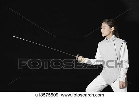Female fencer holding a fencing foil View Large Photo Image Stock Photo - Female fencer holding a fencing foil. Fotosearch