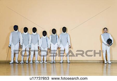 Stock Image - Group of people in fencing costume standing side by side. Fotosearch
