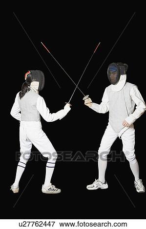 Stock Photo - Man and a woman fencing. Fotosearch