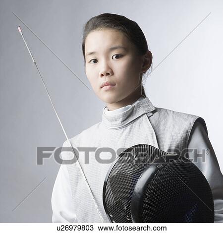 Portrait of a female fencer holding a sword and a fencing mask View Large Photo Image Stock Image - Portrait of a female fencer holding a sword and a fencing mask. Fotosearch