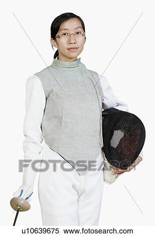 Stock Photography - Portrait of a female fencer holding a fencing foil and a fencing mask. Fotosearch