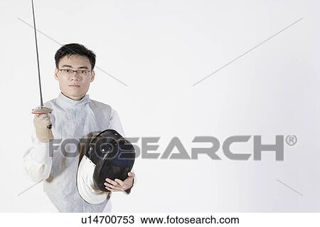 Portrait of a male fencer holding a fencing foil and a fencing mask View Large Photo Image Stock Image - Portrait of a male fencer holding a fencing foil and a fencing mask. Fotosearch