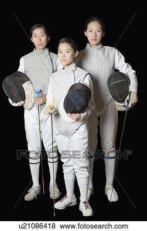 Stock Photo - Portrait of three female fencers holding fencing masks and fencing foils. Fotosearch