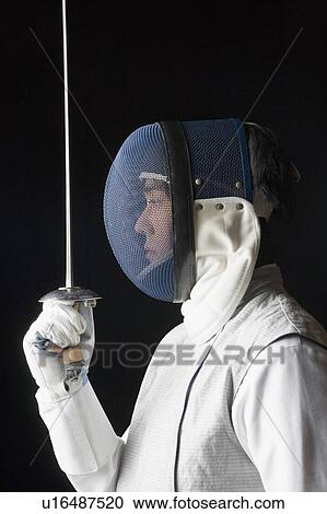 Side profile of a male fencer holding a fencing foil View Large Photo Image Stock Image - Side profile of a male fencer holding a fencing foil. Fotosearch