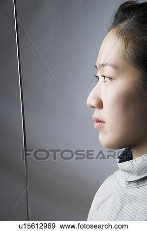 Stock Photo - Close-up of a female fencer holding a sword. Fotosearch