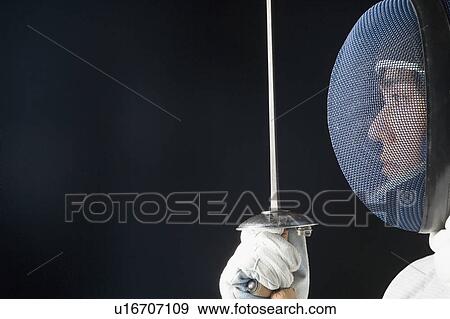 Stock Photo - Close-up of a male fencer holding a fencing foil. Fotosearch