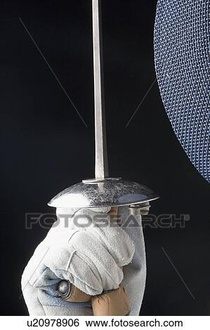 Close-up of a person's hand holding a fencing foil View Large Photo Image Stock Photograph - Close-up of a person's hand holding a fencing foil. Fotosearch