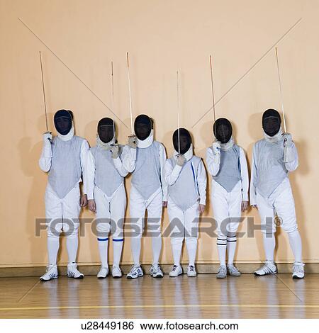 Stock Photograph - Group of people in fencing costume standing side by side. Fotosearch