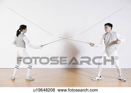 Male and a female fencer fencing View Large Photo Image Stock Photo - Male and a female fencer fencing. Fotosearch