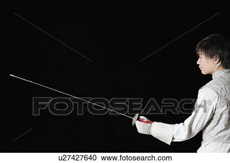 Stock Image - Male fencer holding a fencing foil. Fotosearch
