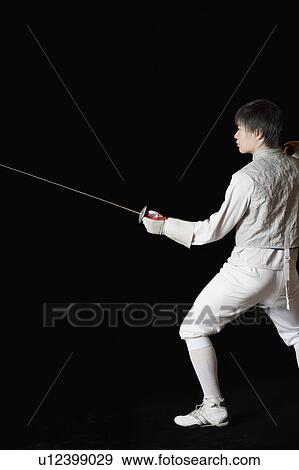 Stock Photo - Male fencer holding a fencing foil. Fotosearch