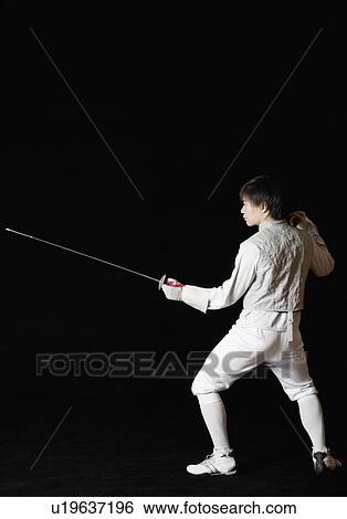 Stock Photograph - Male fencer holding a fencing foil. Fotosearch