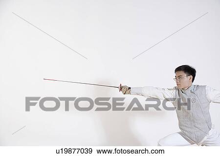 Stock Photo - Male fencer practicing fencing. Fotosearch