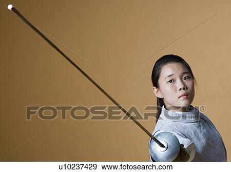 Portrait of a female fencer fencing View Large Photo Image Stock Photo - Portrait of a female fencer fencing. Fotosearch