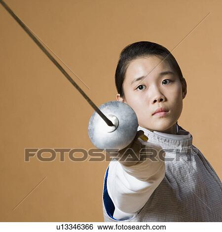 Stock Photograph - Portrait of a female fencer fencing. Fotosearch