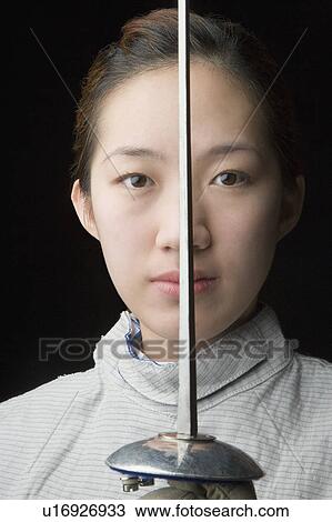 Portrait of a female fencer holding a fencing foil View Large Photo Image Stock Image - Portrait of a female fencer holding a fencing foil. Fotosearch