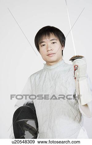 Portrait of a female fencer holding a fencing foil and a fencing mask View Large Photo Image Stock Photo - Portrait of a female fencer holding a fencing foil and a fencing mask. Fotosearch
