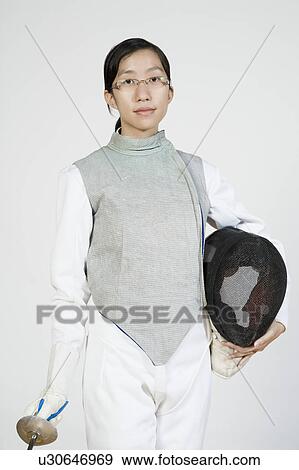 Portrait of a female fencer holding a fencing foil and a fencing mask View Large Photo Image Stock Photo - Portrait of a female fencer holding a fencing foil and a fencing mask. Fotosearch