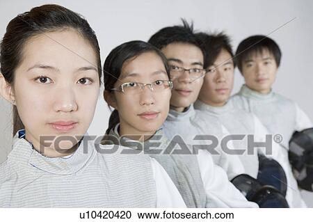 Stock Image - Portrait of two young women and three young men in a row. Fotosearch