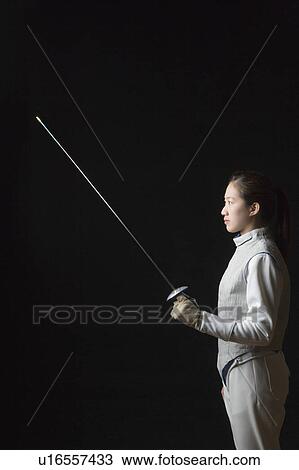 Side profile of a female fencer holding a fencing foil View Large Photo Image Stock Image - Side profile of a female fencer holding a fencing foil. Fotosearch