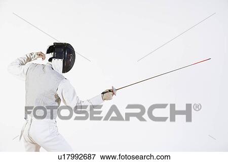 Side profile of a fencer practicing fencing View Large Photo Image Stock Photo - Side profile of a fencer practicing fencing. Fotosearch