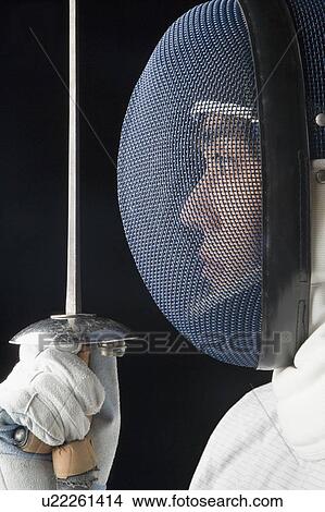 Side profile of a male fencer holding a fencing foil View Large Photo Image Picture - Side profile of a male fencer holding a fencing foil. Fotosearch