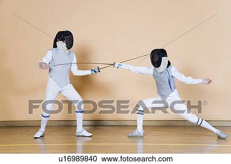 Two fencers fencing View Large Photo Image Stock Image - Two fencers fencing. Fotosearch