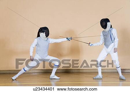 Stock Image - Two fencers fencing. Fotosearch