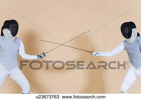 Two fencers fencing View Large Photo Image Stock Image - Two fencers fencing. Fotosearch