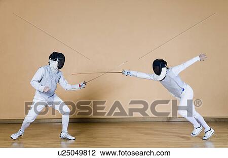 Two fencers fencing View Large Photo Image Stock Image - Two fencers fencing. Fotosearch
