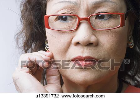 Close-up of a senior woman thinking View Large Photo Image Stock Image - Close-up of a senior woman thinking. Fotosearch